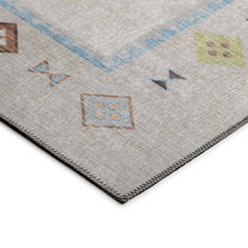 Close-up of the Dalyn Phoenix PH2 Ivory Washable Area Rug. Southwestern style rug with beige, blue, and brown geometric patterns.
