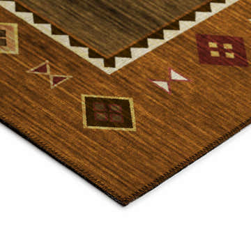 Close-up of the brown, beige, and spice Dalyn Phoenix area rug with a Southwestern geometric pattern.