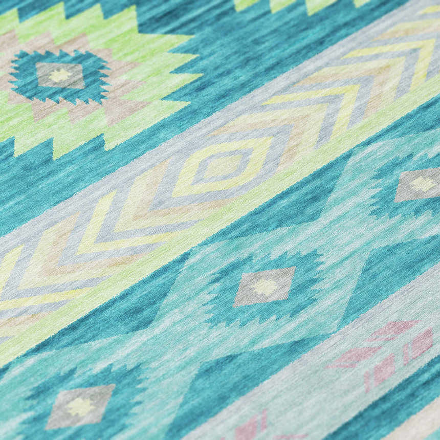 Close-up of Dalyn Phoenix PH3 Teal Washable Area Rug. Southwestern style with teal, lime, and gray geometric pattern.
