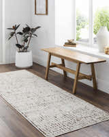 Entryway with Cascade Minimalist Rug, wood bench, dark floors, and white walls. Modern, bright, and inviting. Roomscene-Runner
