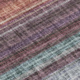Close-up of the Dalyn Luxury Portico Lavender Washable Area Rug. Features woven texture and stripes of purple, blue, and burnt hues.