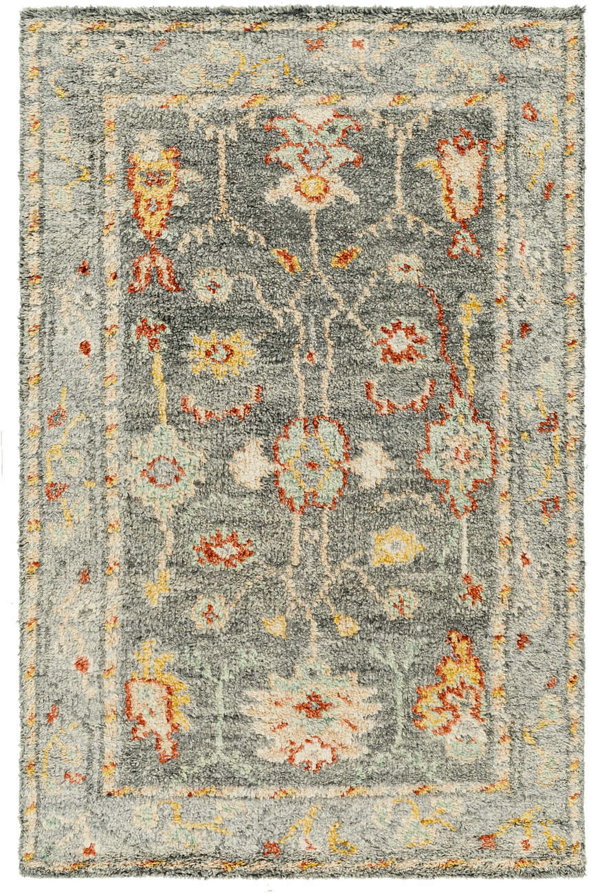 Close-up of the Prosperidad Handmade Wool Rug, featuring a traditional floral pattern in brick red, mustard, and light gray. Design-Rectangle-69