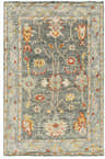 Close-up of the Prosperidad Handmade Wool Rug, featuring a traditional floral pattern in brick red, mustard, and light gray. Design-Rectangle-69