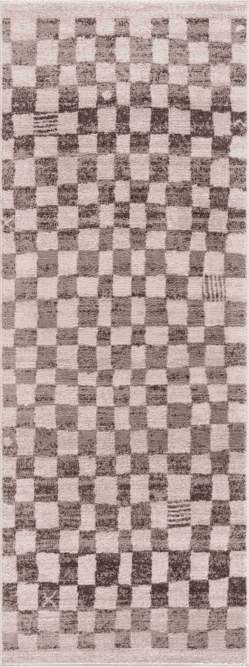 Close-up of the Benjy Irregular Checkboard Rug in beige, cream, and tan. Features a checkered, geometric pattern and soft texture. Design-Runner