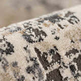 Close up of the Pewamo Area Rug showing its beige, charcoal, and brown contemporary pattern. Fold
