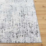 Close-up of the Avital Area Rug. Contemporary design with black, charcoal, gray, and white hues. Machine woven texture. Front