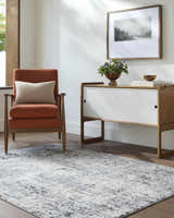 Living room with a gray and white Avital Area Rug, peach chair, and modern console table. Roomscene-Rectangle