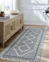 Entryway with Bone Rach Area Rug runner, dark gray pattern, wood console table, and light wood floors. Roomscene-Runner