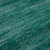 Close-up of the Dalyn Rafia RF100 Emerald area rug, showing its light green wool texture and hand-loomed construction.
