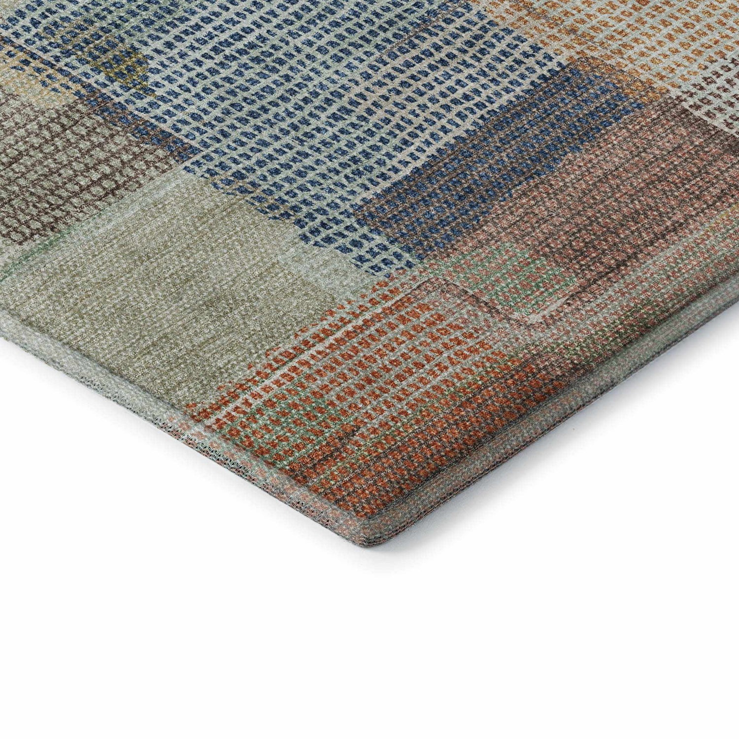 Close-up of the Dalyn Luxury Ravenna RN10 Putty Washable Area Rug featuring a geometric, patchwork design in beige, blue, coral, and green.