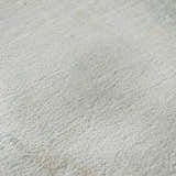 Close-up of the plush texture of the Dalyn Luxury Ravenna RN1 Seafoam Washable Area Rug in beige, ivory, sage, and teal.