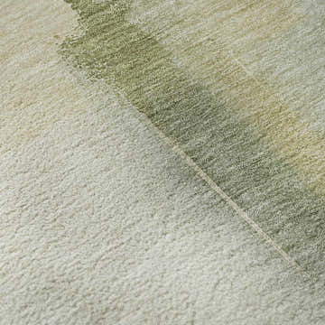 Close-up of Dalyn Luxury Ravenna RN9 Aloe Washable Area Rug. Features aloe, beige, and green hues with a soft, textured pile.
