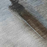 Close-up of the Dalyn Luxury Ravenna RN9 Taupe Washable Area Rug, showing beige, chestnut, and light blue tones.