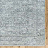 Close-up of Livabliss x Galey Alix Maria Elena II rug. Vintage medallion pattern in cream, black, and gray on wood floor. Corner
