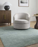 Living room scene with a Livabliss x Galey Alix Maria Elena II rug, cream chair, wood cabinet, and neutral decor. Roomscene-Rectangle