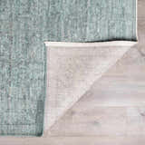 Close-up of Livabliss x Galey Alix Maria Elena II rug. Vintage medallion pattern in black, cream, and gray on a light wood floor. Fold