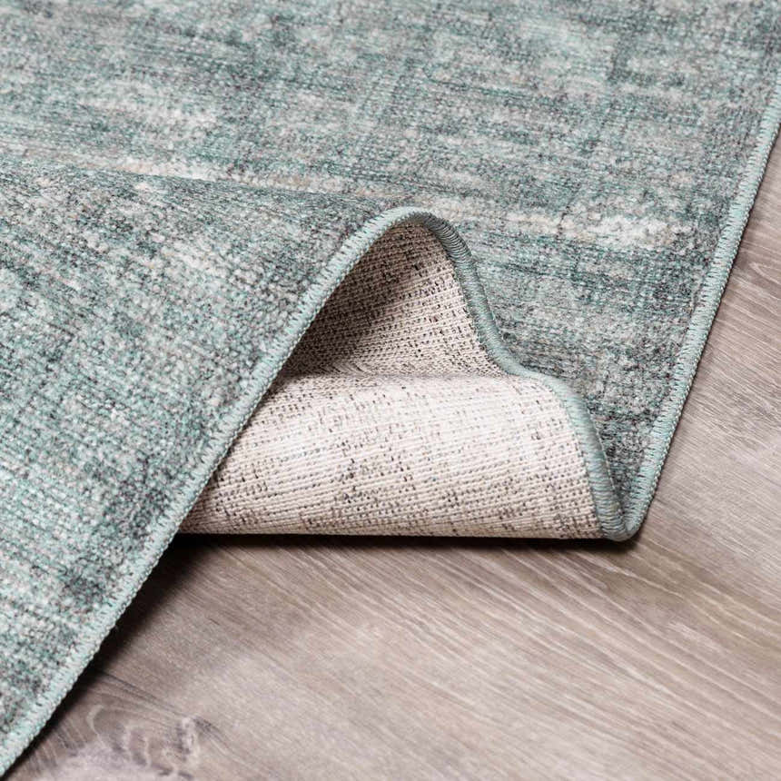Close-up of Livabliss x Galey Alix Maria Elena II rug showing its vintage medallion pattern and black, cream and gray colors. Fold