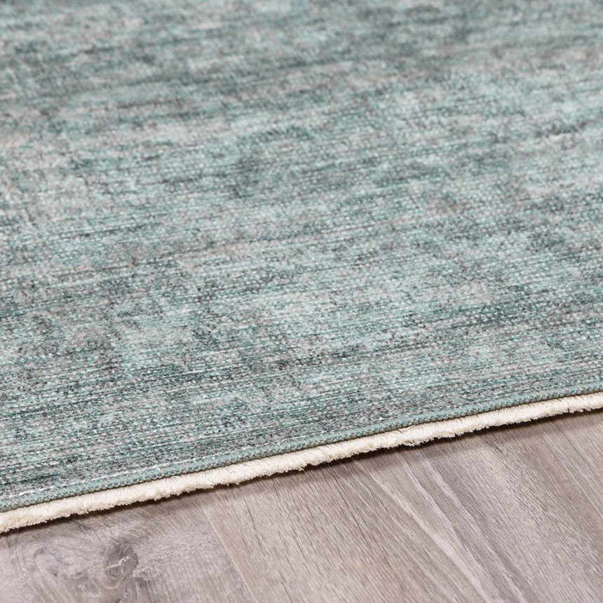 Close up of the Livabliss x Galey Alix Maria Elena II rug. Features a vintage medallion pattern in black, cream, and gray. Corner