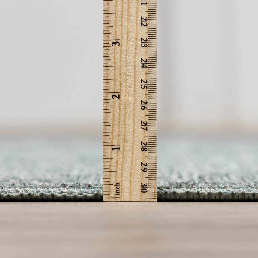 Close-up of the Livabliss x Galey Alix Maria Elena II rug pile height, showing its texture with a ruler for scale. Pile