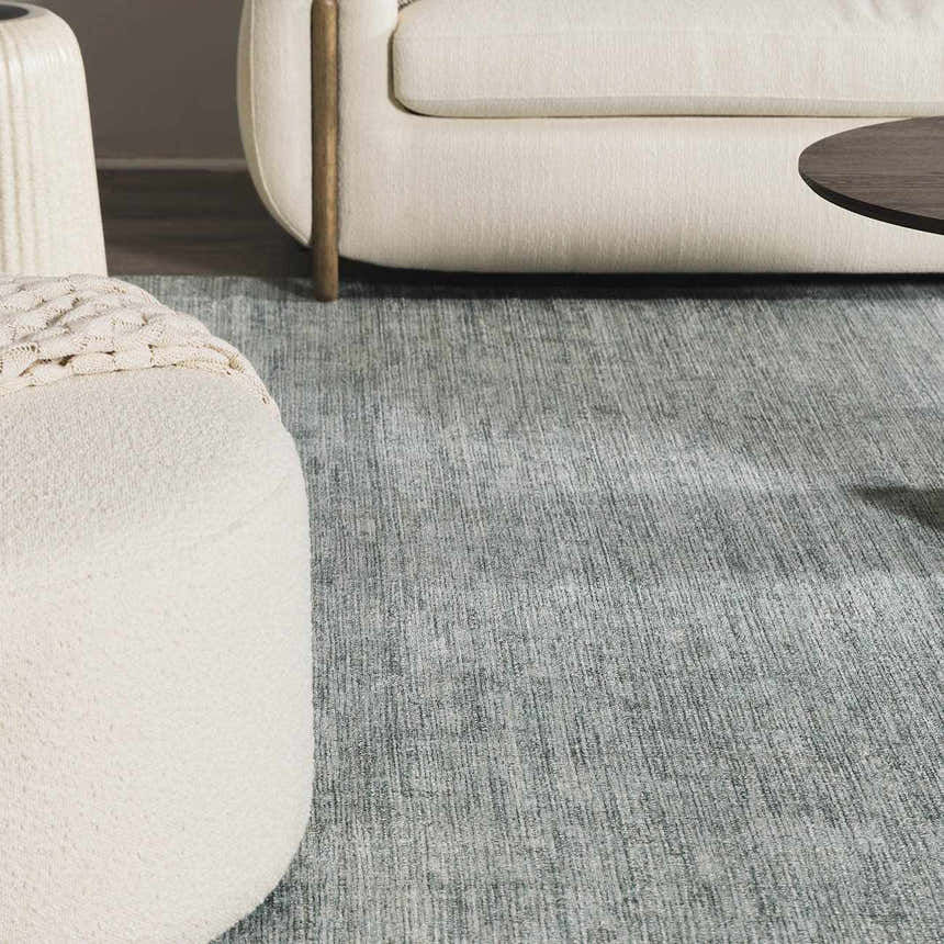 Close-up of Livabliss x Galey Alix Maria Elena II rug in gray. Cream sofa and ottoman add a cozy feel to the room. Roomscene-Rectangle