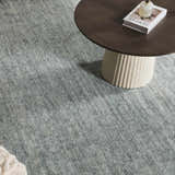 Close up of Livabliss x Galey Alix Maria Elena II rug in medium gray under a round wood coffee table. Roomscene-Rectangle