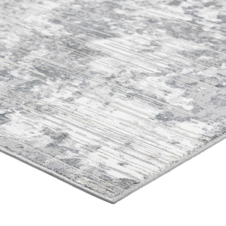 Close-up of the Dalyn Rhodes RR4 Gray Area Rug. Features a distressed, abstract pattern in silver gray, cream, and taupe.