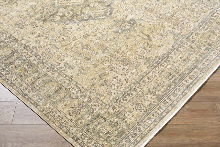 Close-up of the hand-crafted Becki Beige Owens x Livabliss Renaissance Area Rug showing beige, tan, and brown traditional pattern. Corner