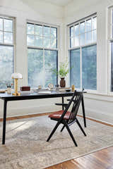 Bright home office with Becki Beige Owens x Livabliss Renaissance Area Rug, black desk, and chair. Roomscene-Rectangle