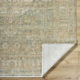 Close-up of Becki Owens x Livabliss Renaissance BORI-2302 rug. Beige, denim, coral, and tan traditional floral pattern. 100% wool. Fold