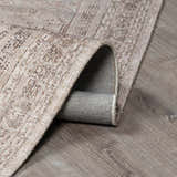 Close-up of the beige and dark brown Luciana III Traditional Medallion Area Rug showing texture and backing. Fold