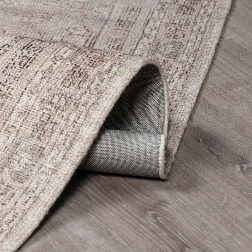 Close-up of the beige and dark brown Luciana III Traditional Medallion Area Rug showing texture and backing. Fold