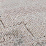Close-up of the beige Luciana III Traditional Medallion Area Rug showing its hand-tufted texture and dark brown pattern. Texture