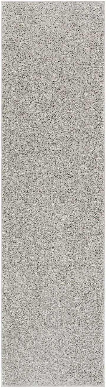 Close-up of the Judy Solid Gray Washable Shag Rug, showing its soft texture and light gray color. Design-Runner-2710