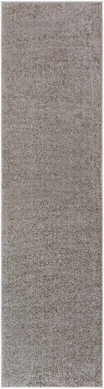 Close-up of the Judy Solid Dark Gray Washable Shag Rug, showing its soft, textured polyester pile and neutral gray color. Design-Runner-2710