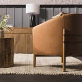 Living room scene with a tan leather chair on a cream Salvo Luxury Hand Woven Wool Area Rug. Styleshot