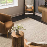 Living room scene with tan armchairs and a cream Salvo Luxury Hand Woven Wool Area Rug on dark floors. Roomscene-Rectangle