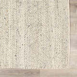 Close-up of the hand woven Salvo Luxury Wool Area Rug. Cream and ivory tones with a textured, braided design. Swatch