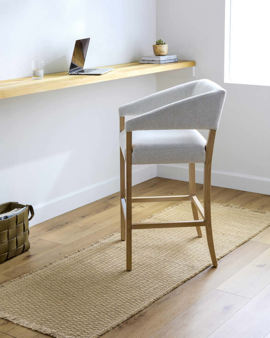 Home office with Kimi Jute Area Rug runner, light wood floors, and a modern gray chair. Minimalist, bright, and airy. Roomscene-Runner