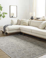 Living room with a cream sectional and the Ren Outdoor Becki Owens x LIVABLISS BOMG-2306 Washable Area Rug. Roomscene-Rectangle