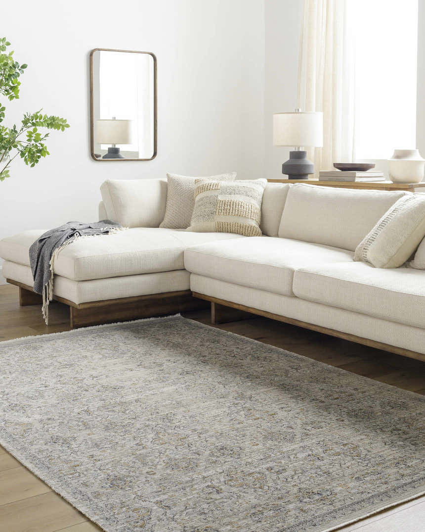 Living room with a cream sectional and the Ren Outdoor Becki Owens x LIVABLISS BOMG-2306 Washable Area Rug. Roomscene-Rectangle