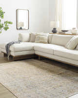 Living room scene with a Ren Outdoor Becki Owens x LIVABLISS rug, cream sectional sofa, wood floors, and neutral decor. Roomscene-Rectangle