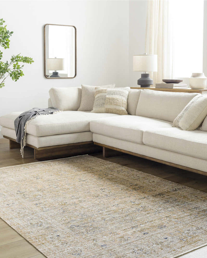 Living room scene with a Ren Outdoor Becki Owens x LIVABLISS rug, cream sectional sofa, wood floors, and neutral decor. Roomscene-Rectangle