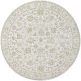Close-up of the round Sashi Tan Luxe Area Rug, featuring a traditional floral pattern in tan, ash, and light silver. Design-Round-7