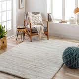 Cozy living room with Livabliss Cloudy Shag rug, gray chair, and natural wood accents. Contemporary style. Roomscene-Rectangle