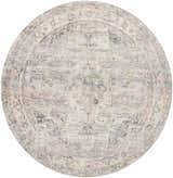 Close-up of round Addax Area Rug: neutral tones, traditional pattern in gray, brown, and blue. Machine woven polyester rug. Design-Round-67