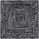 Close-up of the hand woven Kenyi Black Area Rug. Features a contemporary black and white concentric square design. Texture