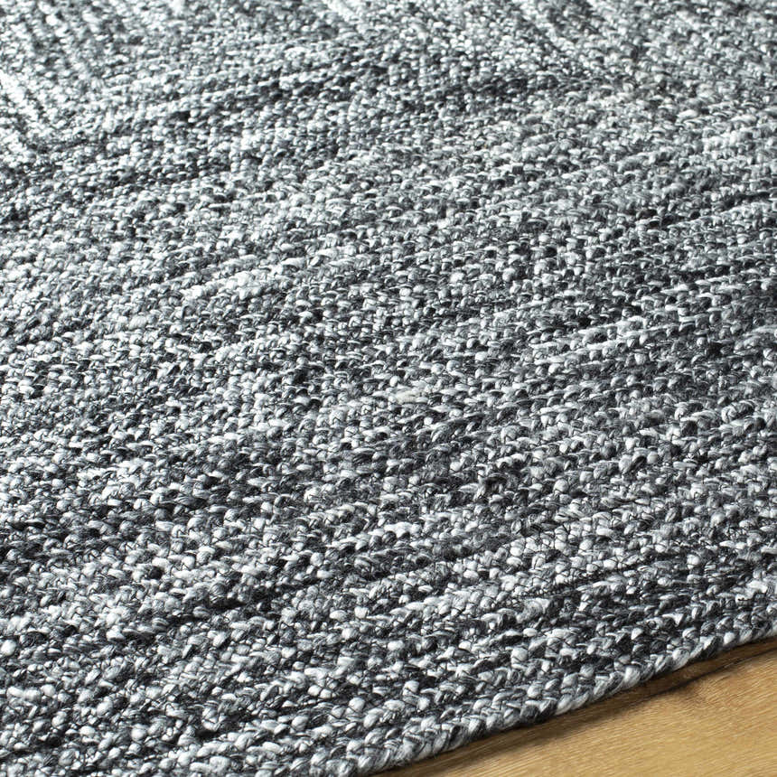 Close-up of the hand woven Kenyi Black Area Rug showing its black and white textured pattern. Texture