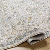 Close-up of the Annie Cream Textured Rug showing its detailed floral pattern and soft texture on a wood floor. Fold