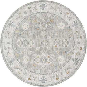 Close-up of the round Hafsa Textured Rug. Gray, nutmeg, and blue floral pattern on a light gray background. Design-Round