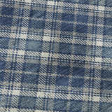 Close-up of the Dalyn Luxury Soft Essentials SE3 Navy Washable Area Rug featuring a blue, gray, and white plaid pattern.